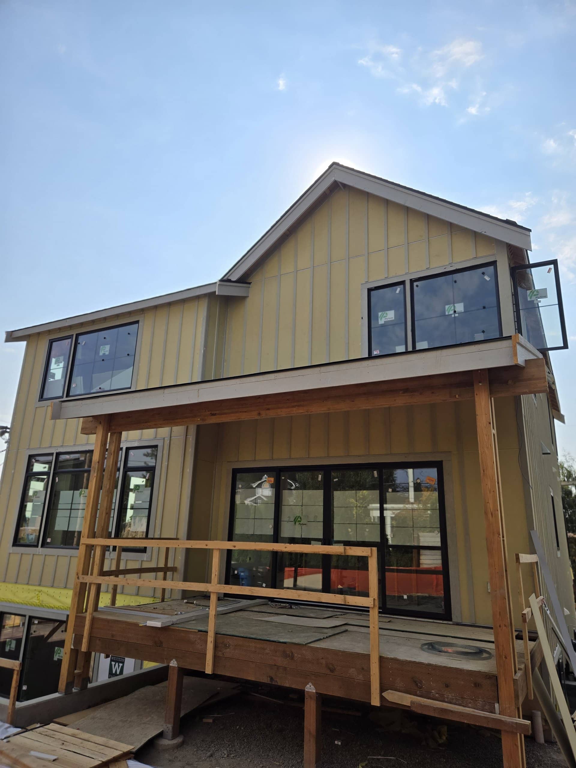 Board-and-batten siding, large windows, deck framing