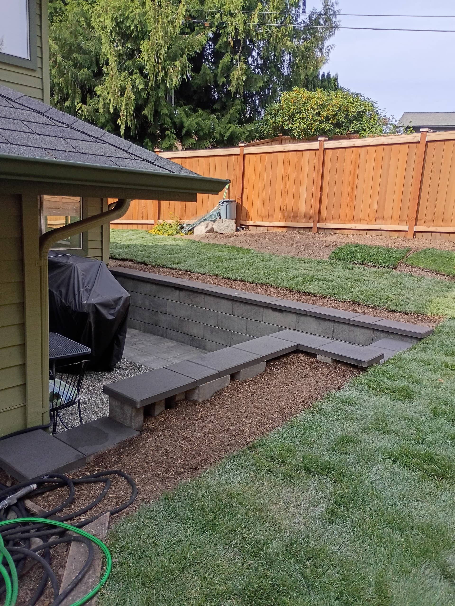 Sunken patio retaining wall with steps and new sod