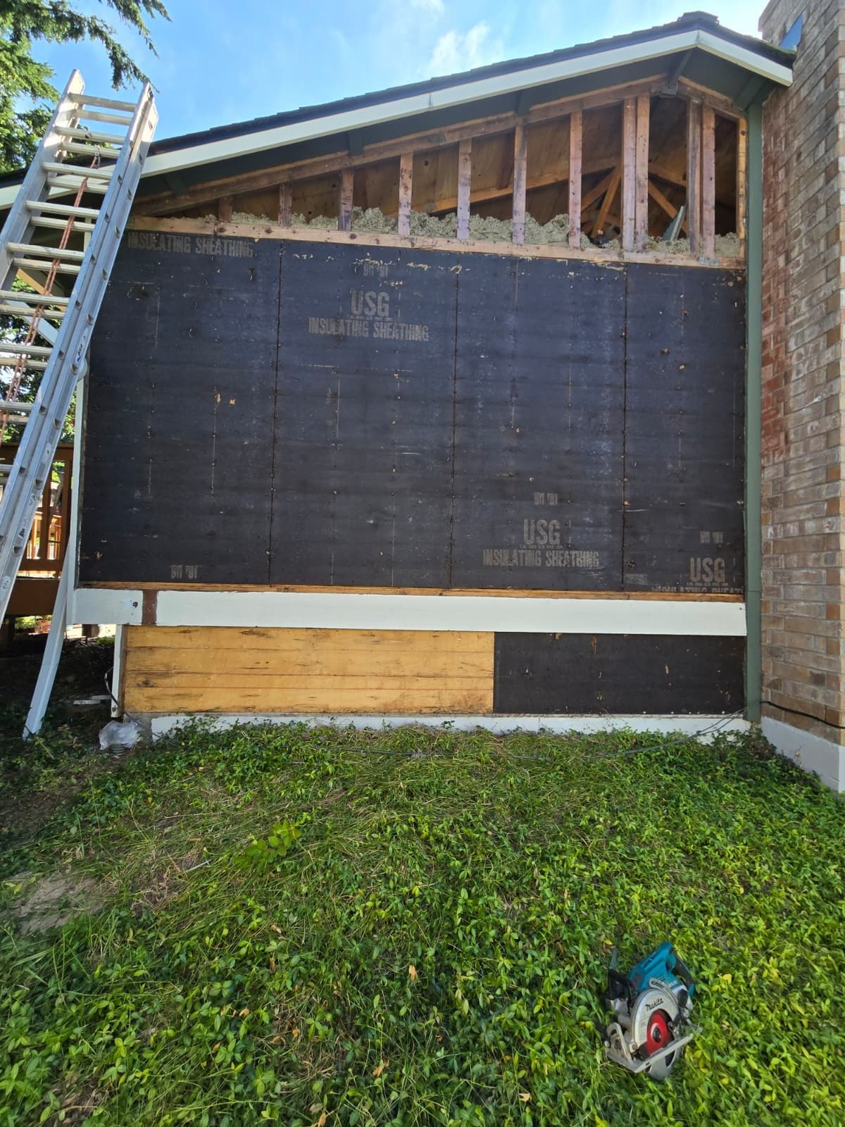 Before: Old siding removed, sheathing exposed