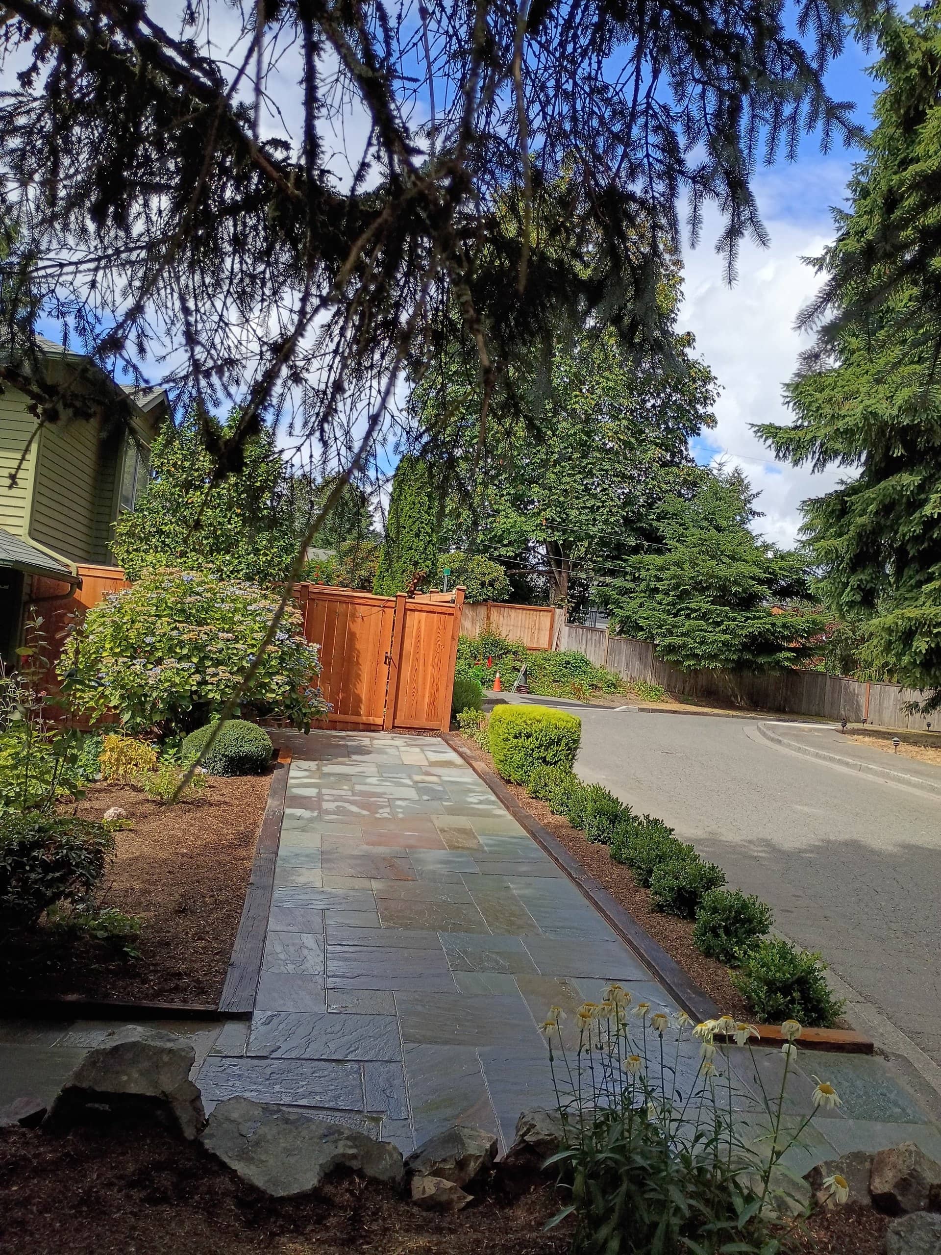 Flagstone walkway to cedar gate, wide angle
